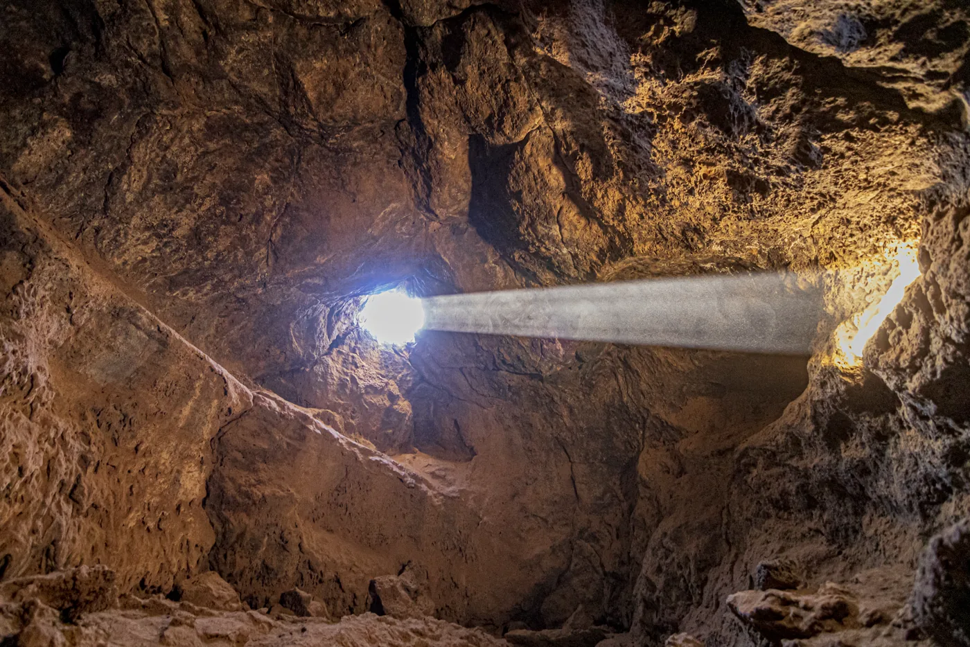Lake Mead cave interior with a light beam piercing through darkness