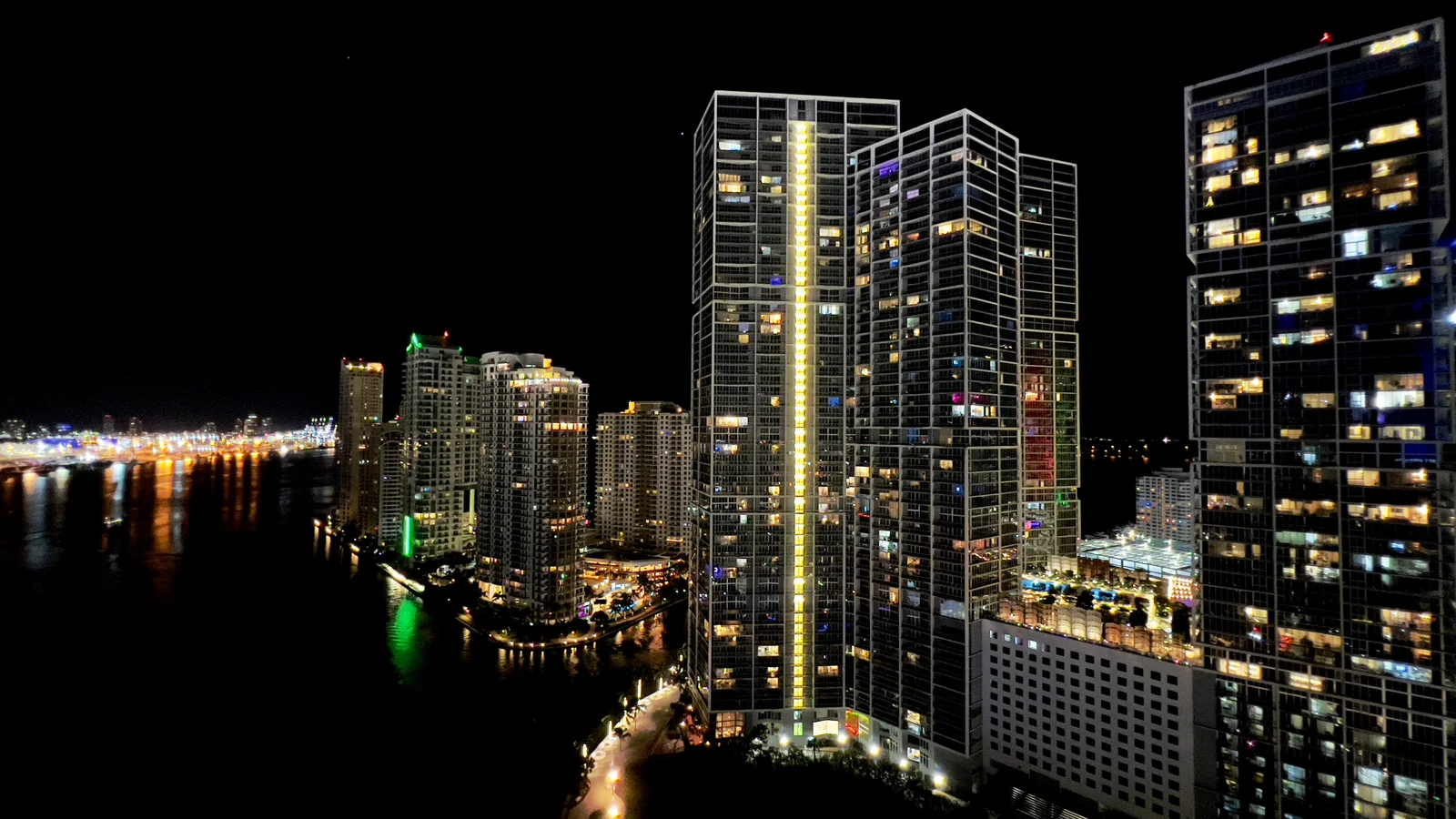 Downtown Miami skyline at night from above, lit high-rises along the waterfront