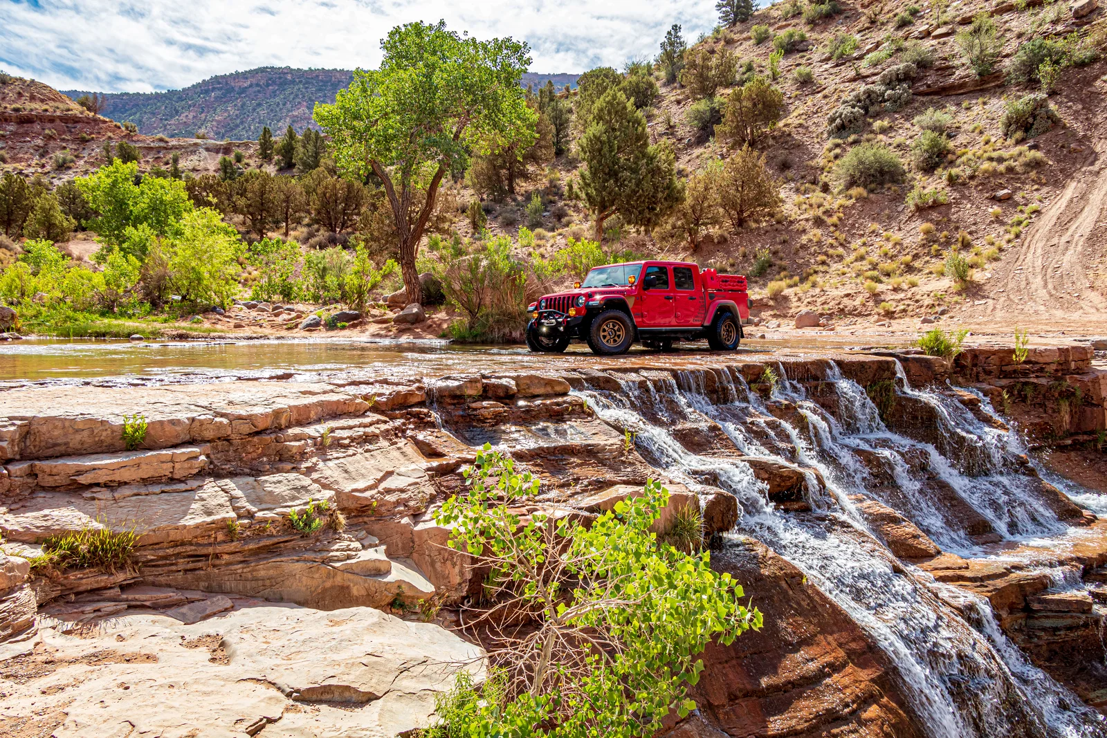Toquerville Falls cascading over red rock ledges in the southern Utah desert